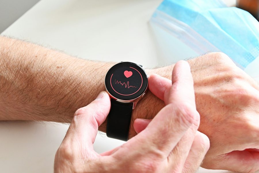 Smartwatch displaying heart rate for remote patient monitoring